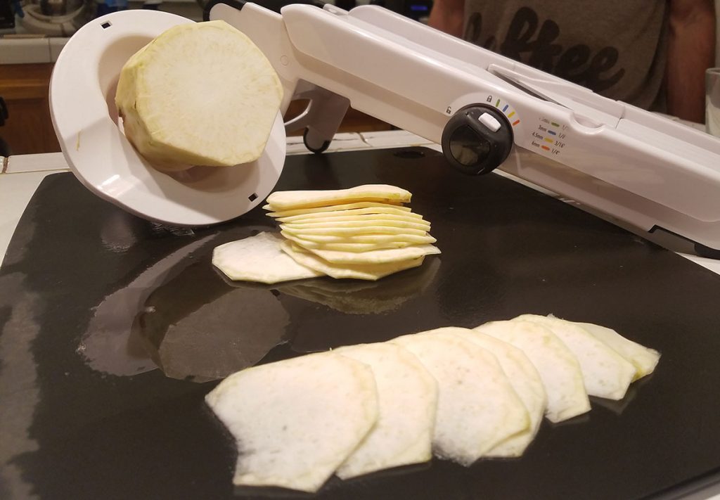 Slicing celeriac with a mandolin