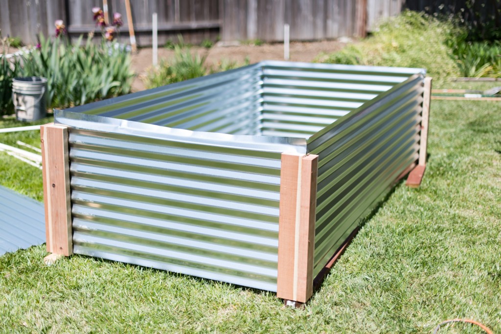 All four sides of the raised metal garden bed screwed together, upside down