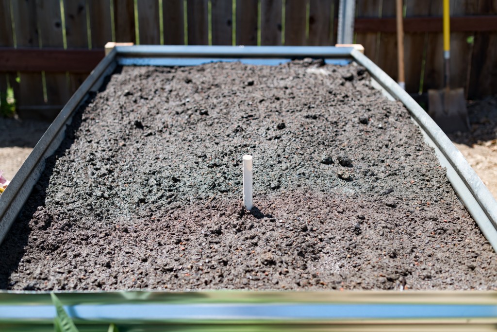 Filling the metal raised garden beds up with dirt