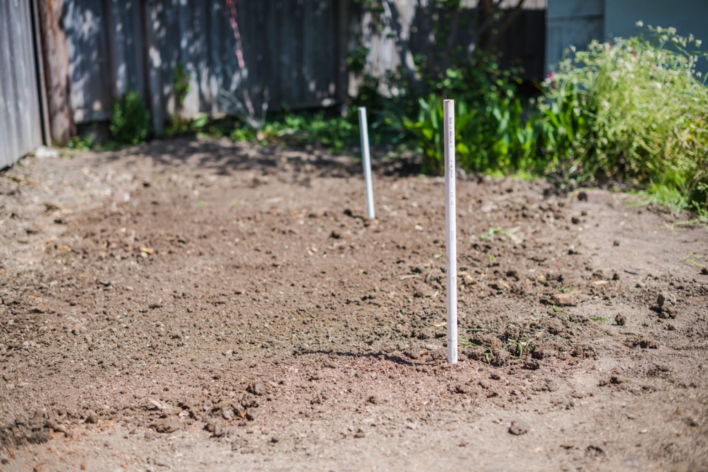 Filling in the irrigation trench and ready to move the metal raised garden beds in place