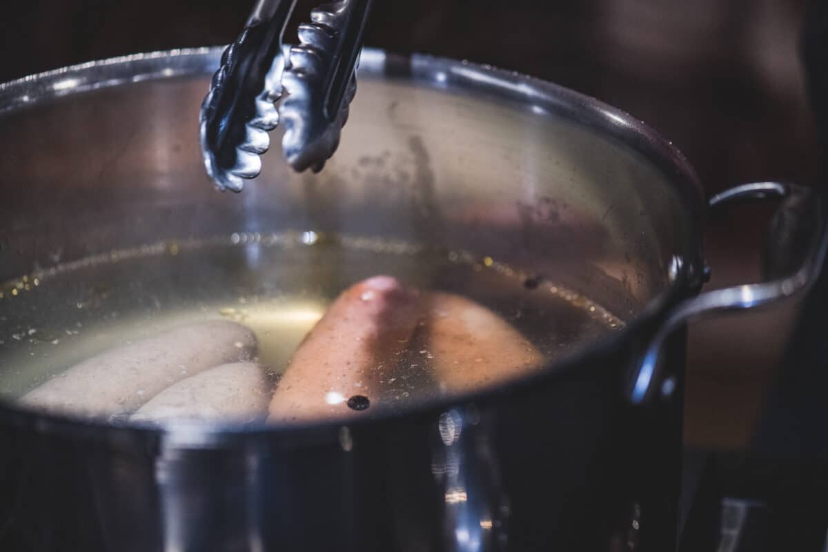 Cook the sausages in boiling water.