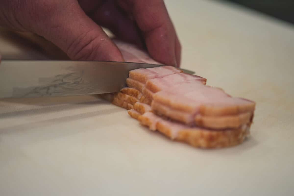 Cutting bacon into 1-inch pieces