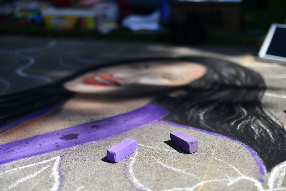 Chalk on the ground beside unfinished chalk artwork