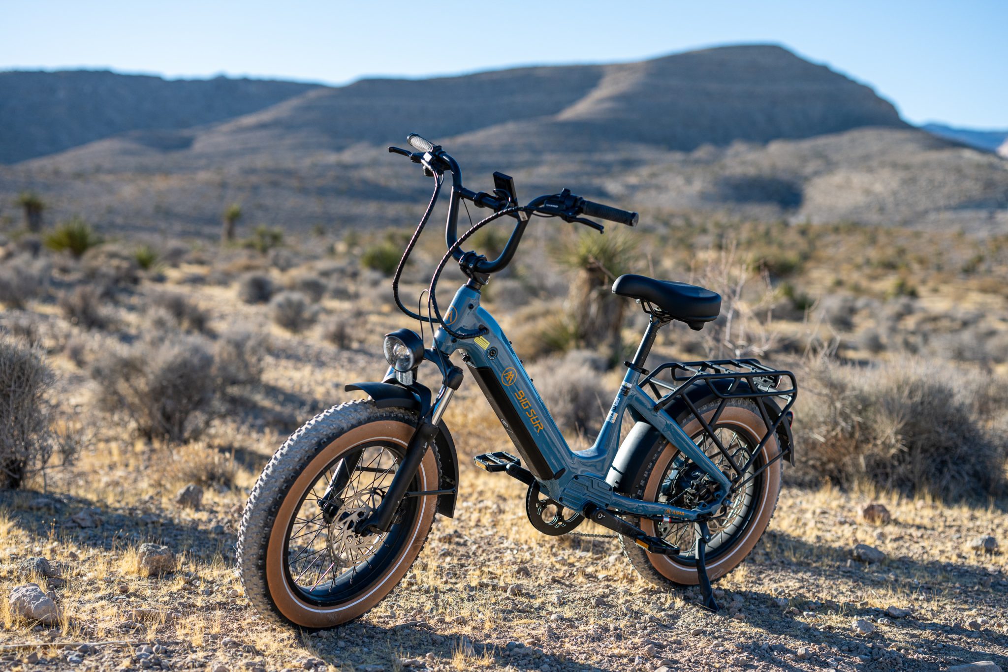 Riding the aima 2025 big sur ebike through red rock and blue diamond front side view