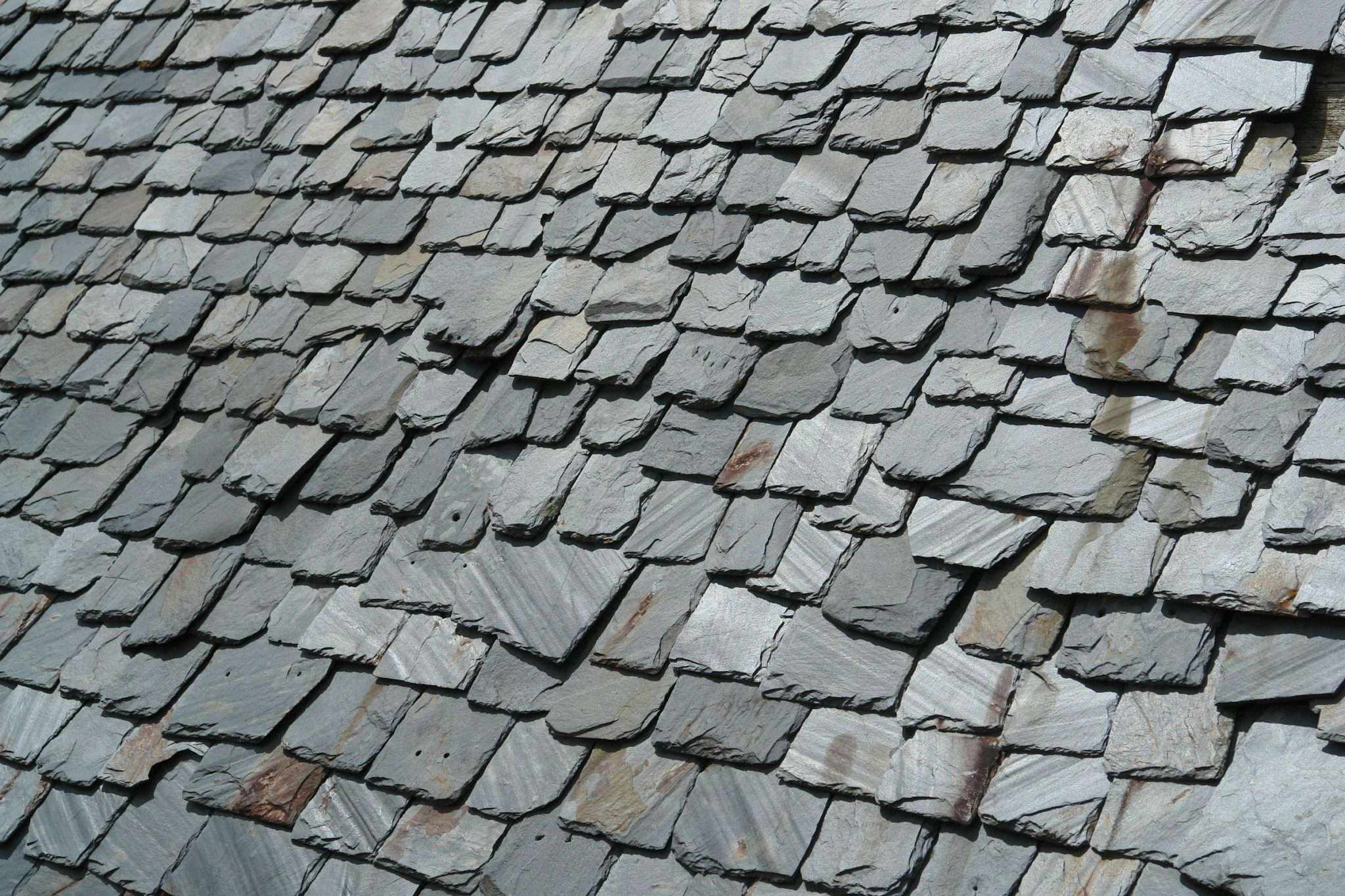 The timeless patina of slate roofs reflects the intentionality of builders who value enduring design