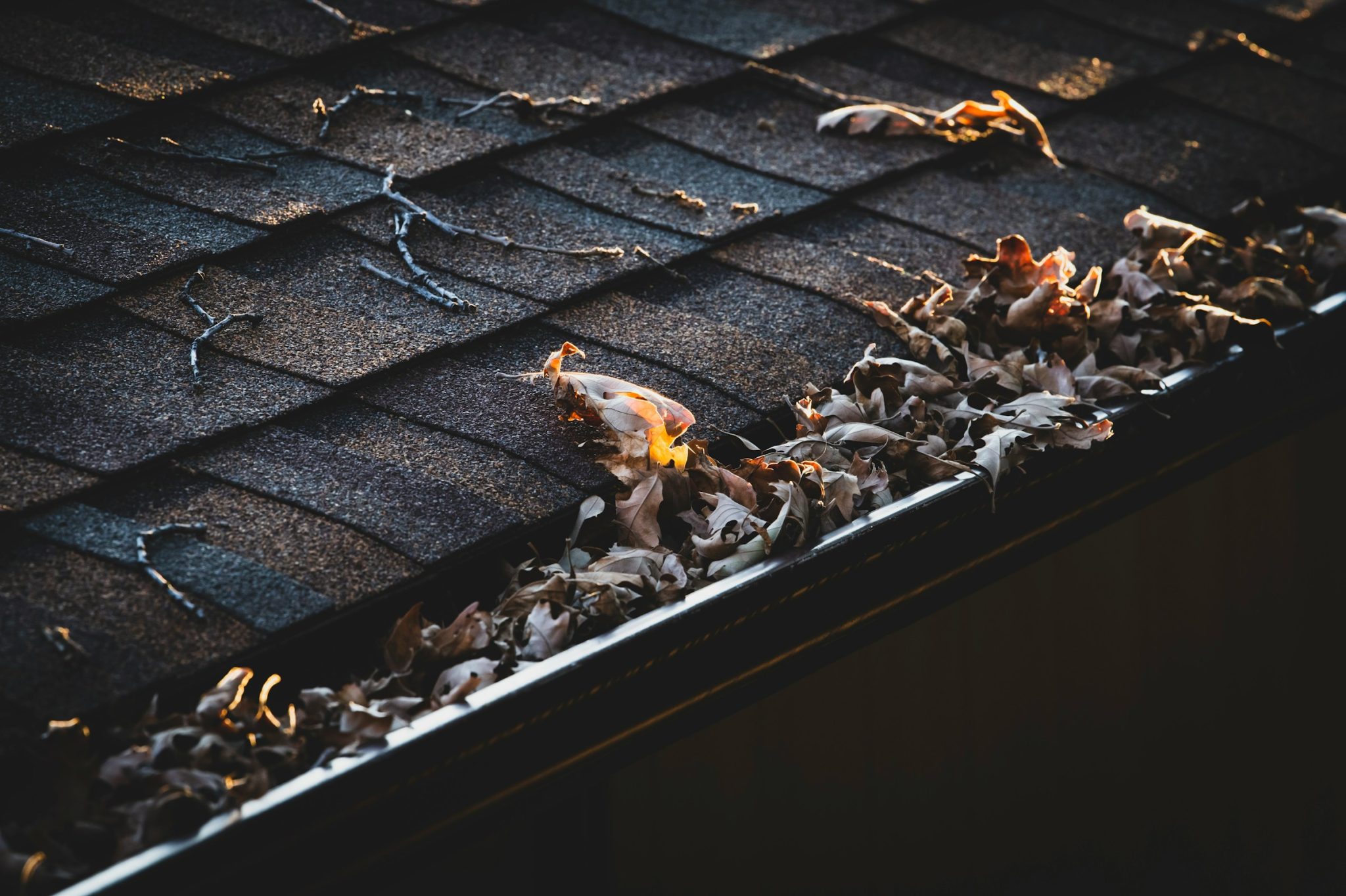 Cleaning gutters with a pressure washer