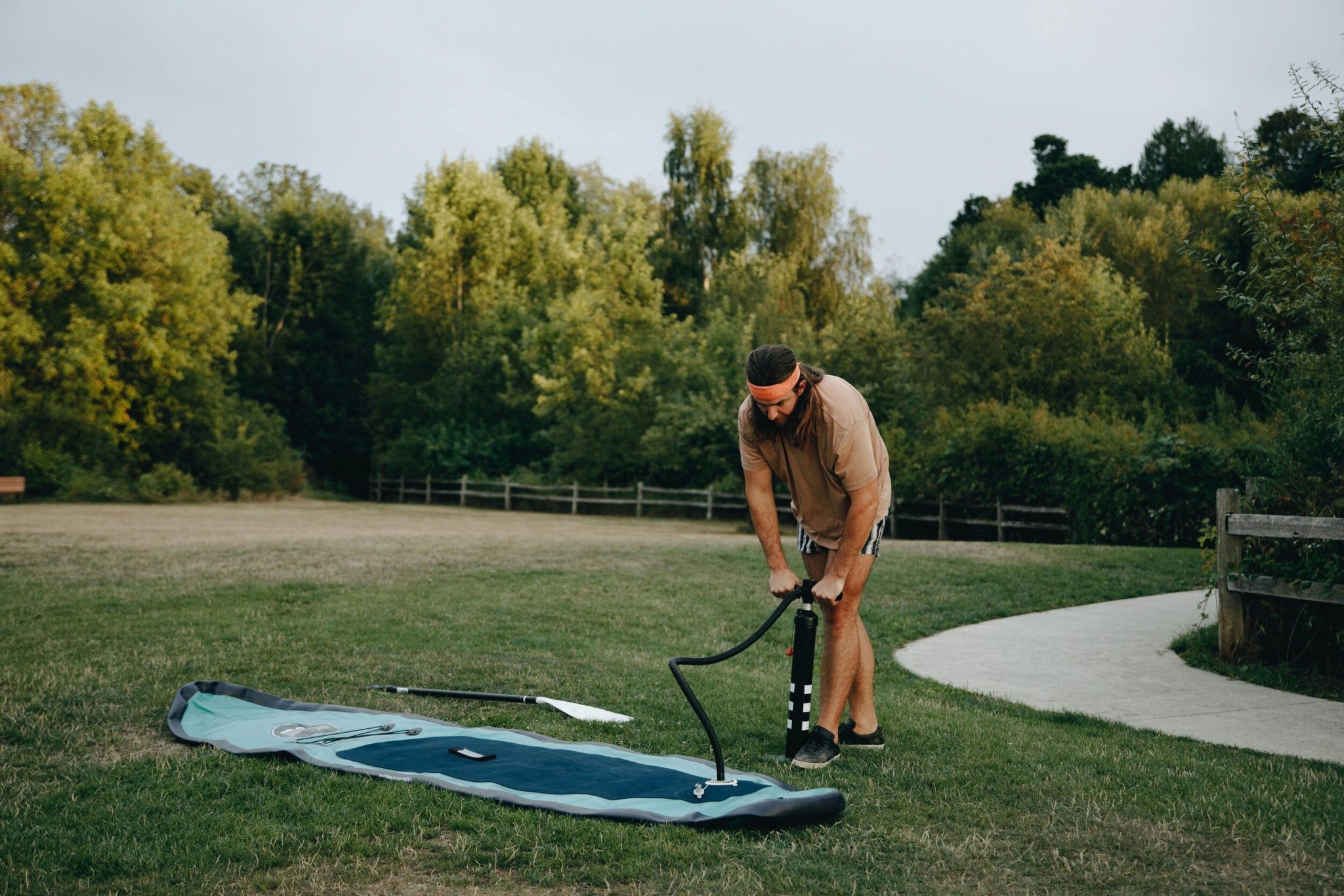 Inflating a stand-up paddleboard with a hand pump before heading out on the water