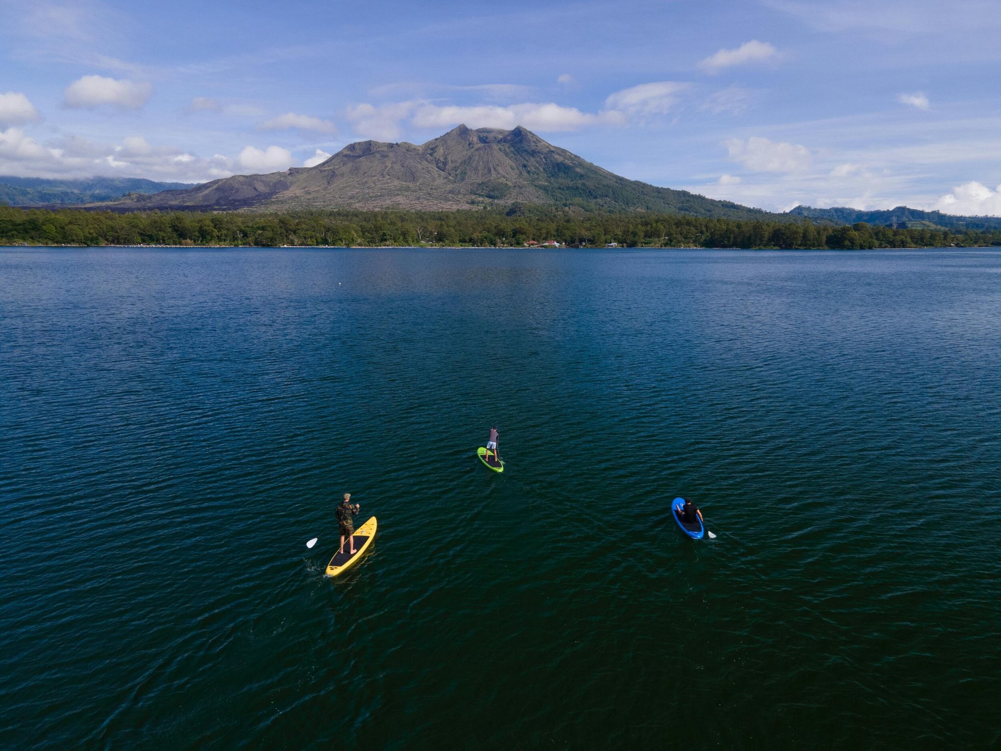 Aerial view of paddleboarders on a mountain lake