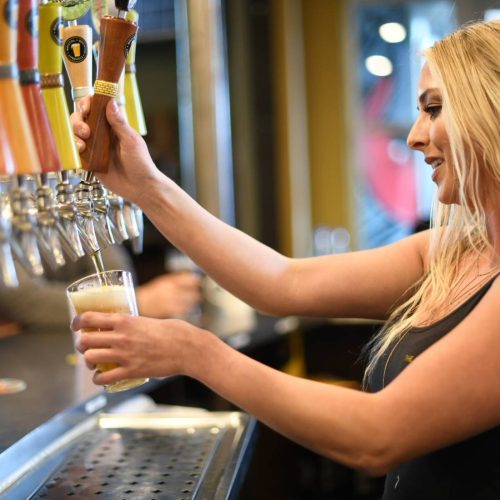 Bartender pouring a craft beer at the taps during sacramento beer week