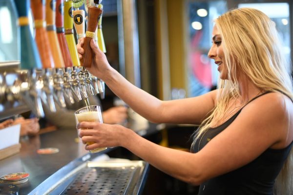 Bartender pouring a craft beer at the taps during sacramento beer week