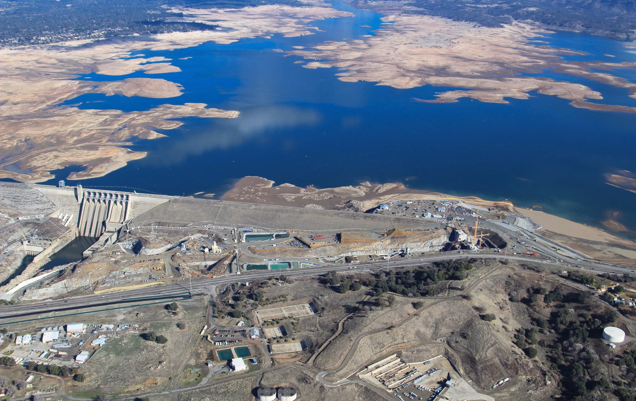 Aerial view of folsom lake at low water during the 2014 drought with auxiliary spillway construction underway