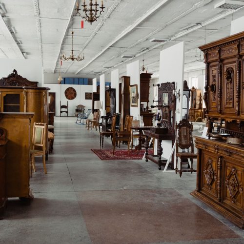 A showroom of antique wooden furniture on display in a sacramento shop