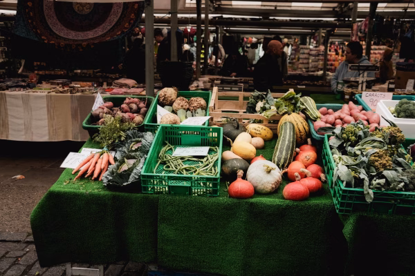 Colorful fresh vegetables on display at an outdoor farmers market stall