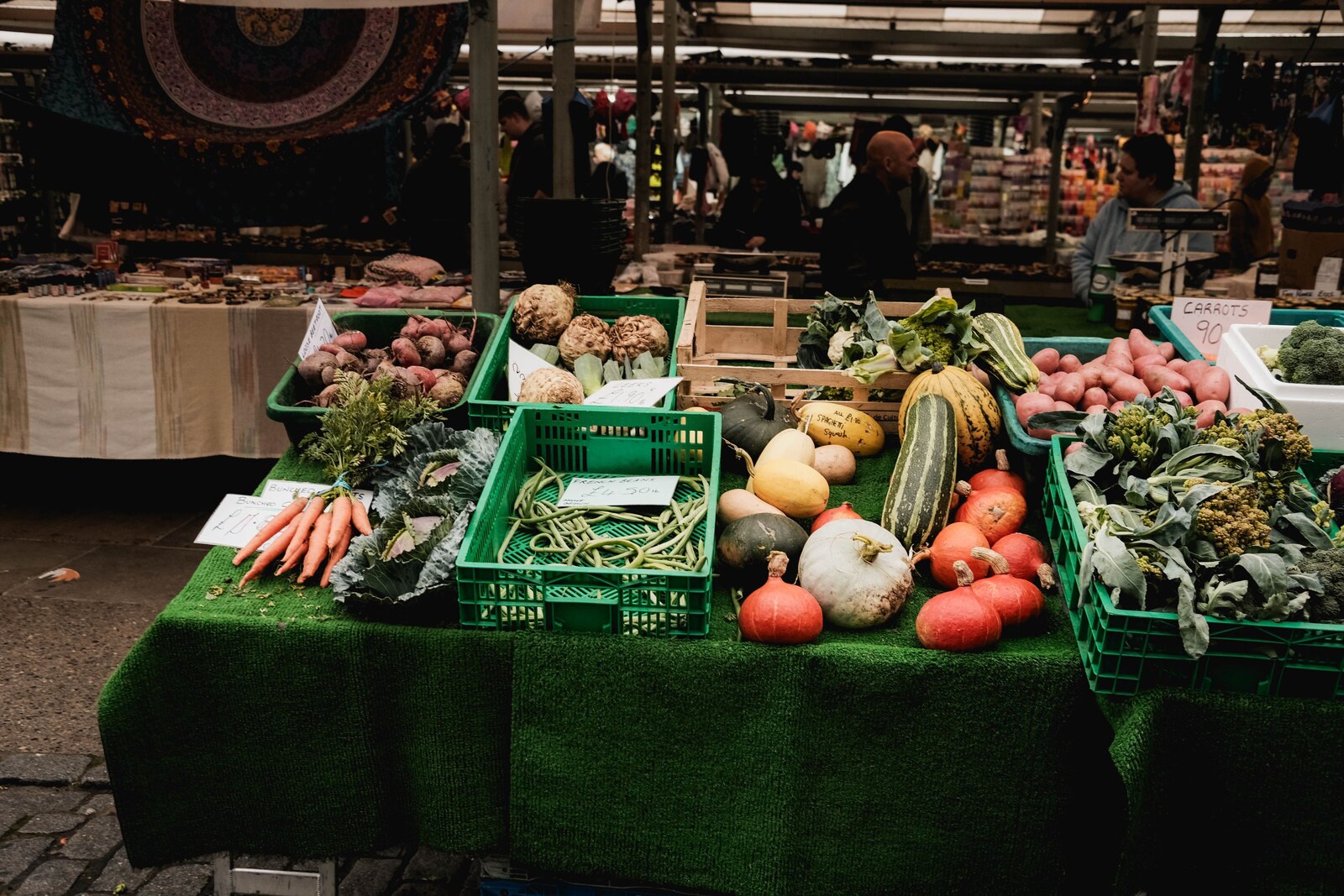 Colorful fresh vegetables on display at an outdoor farmers market stall