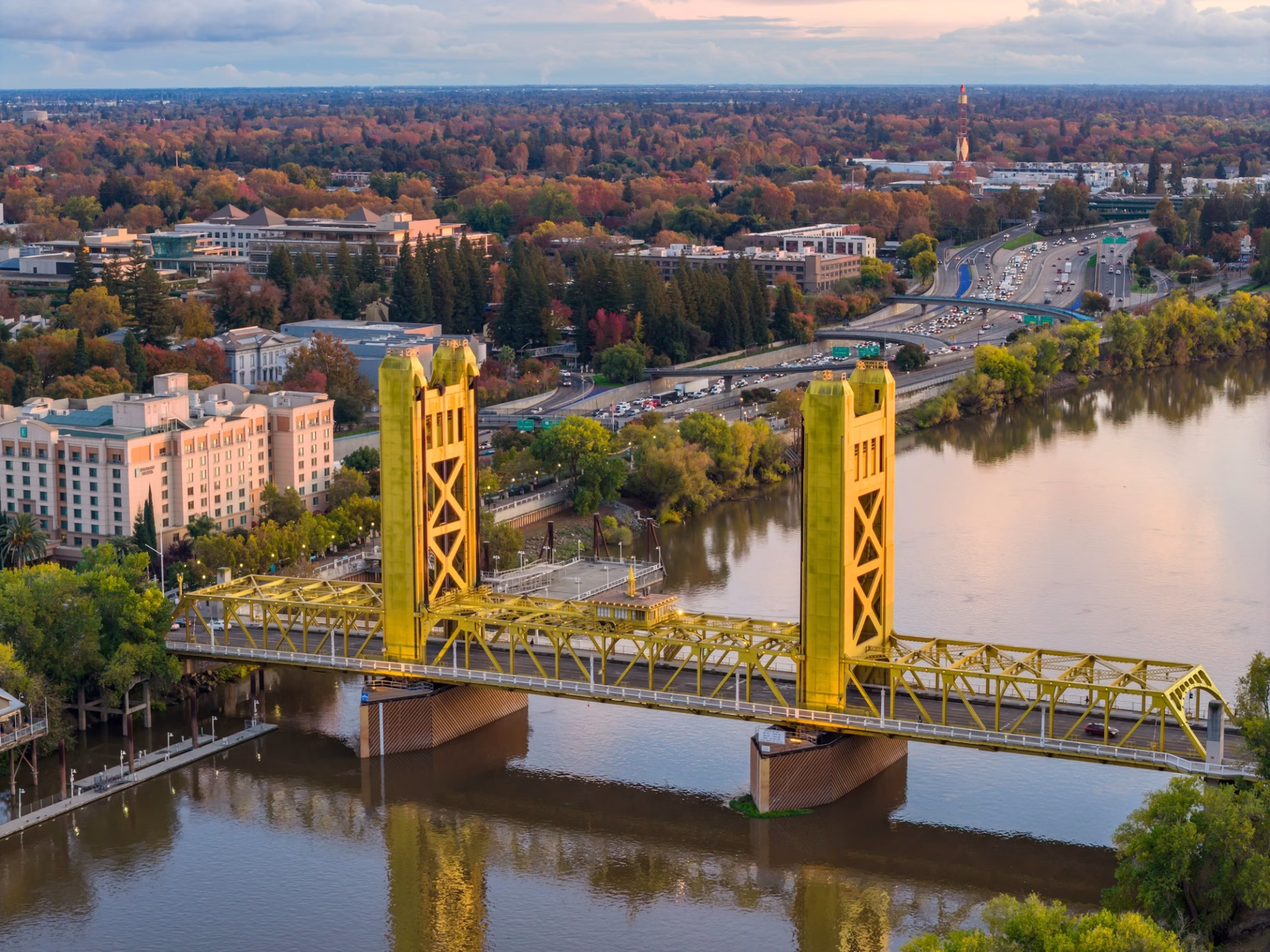 Sacramento tower bridge over the river at golden hour with autumn foliage
