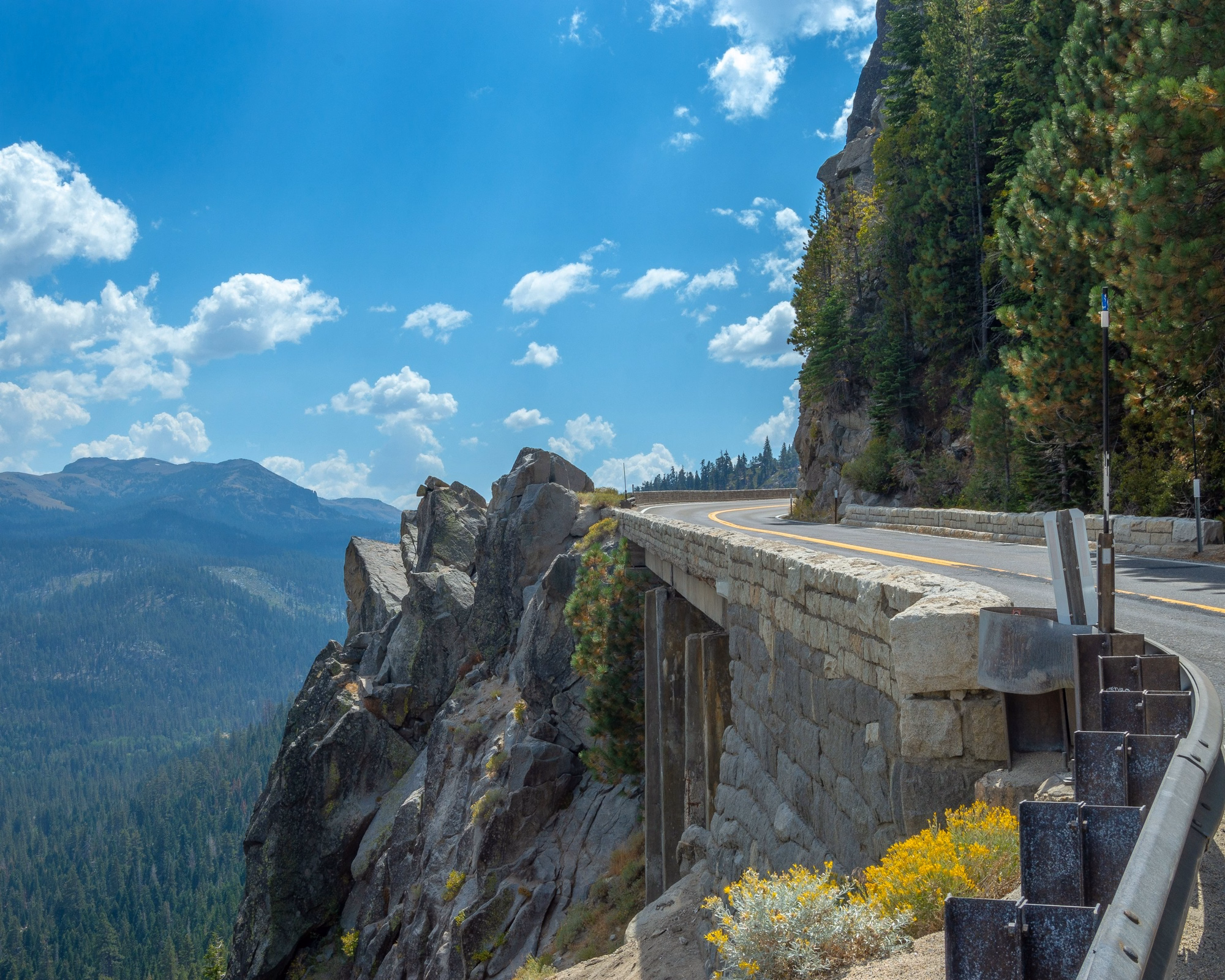 Mountain highway curving along a granite ridge in the sierra nevada