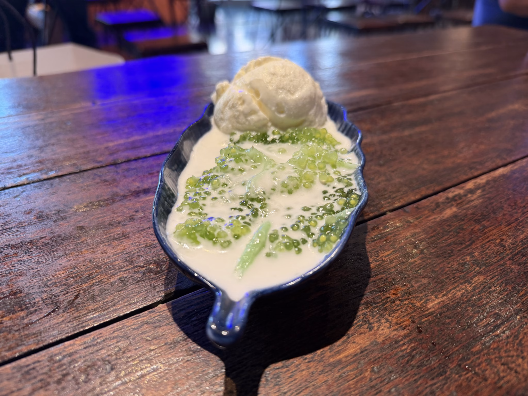 Sago pudding with green sago pearls in coconut milk topped with a scoop of ice cream at kin thai street eatery