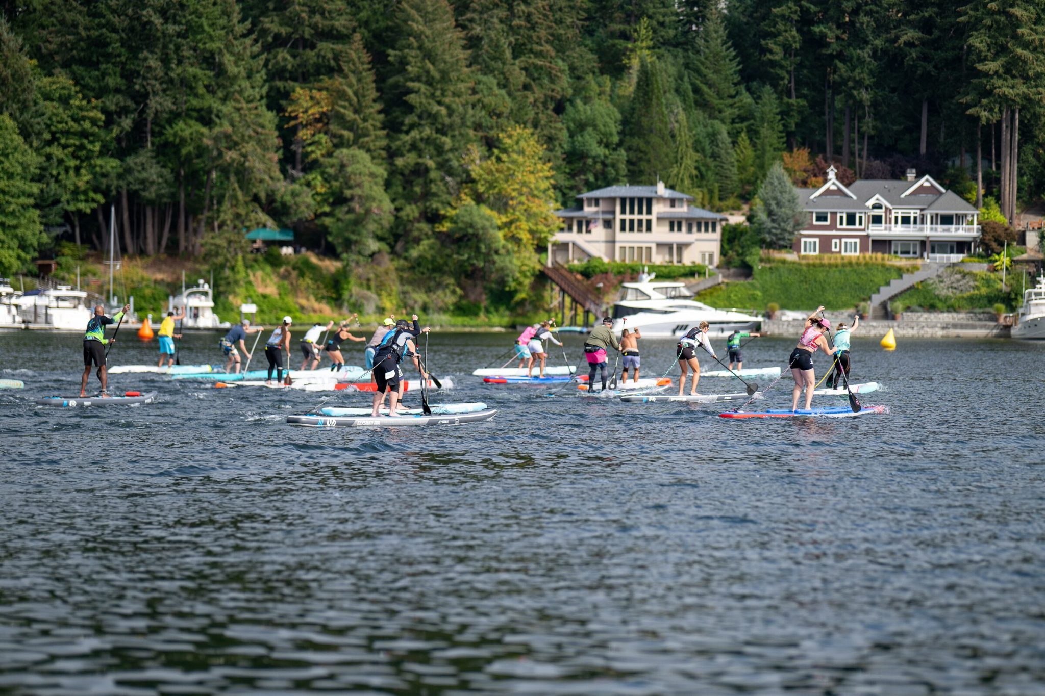 Paddlers on inflatable and hardboard race boards pulling away from the start of the 5k at the 2026 usa sup national championships in gig harbor, washington