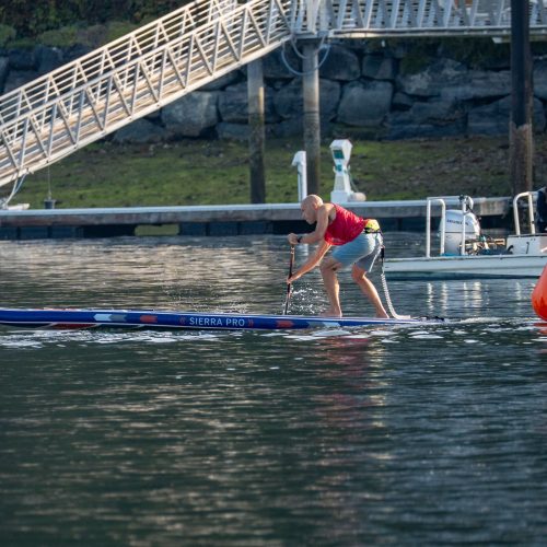 Michael kahn paddling a venture wild sierra pro inflatable race board toward an orange turn buoy on the technical course at the 2026 usa sup national championships