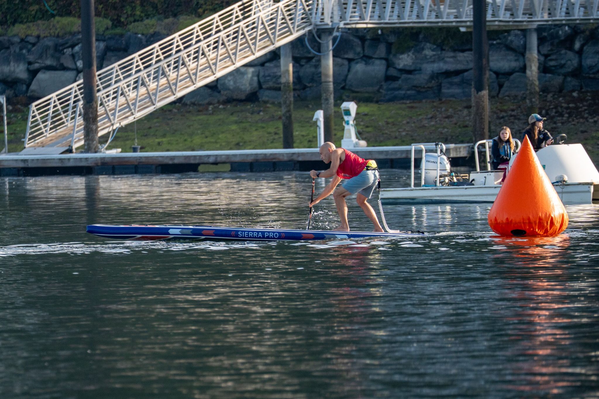 Michael kahn paddling a venture wild sierra pro inflatable race board toward an orange turn buoy on the technical course at the 2026 usa sup national championships